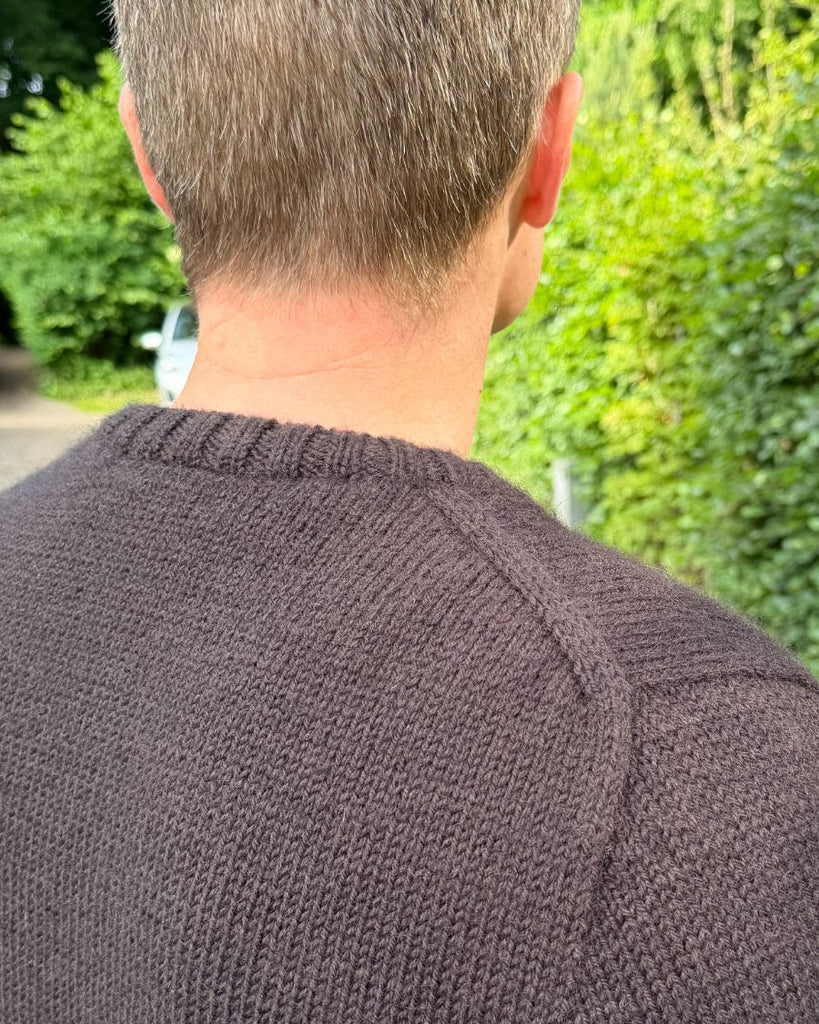 Mand iført brun Niels Sweater set bagfra med fokus på skulderen