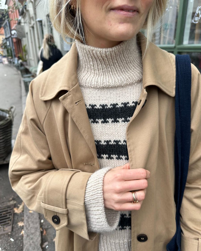 Kvinde iført hvid og grå Key Sweater 