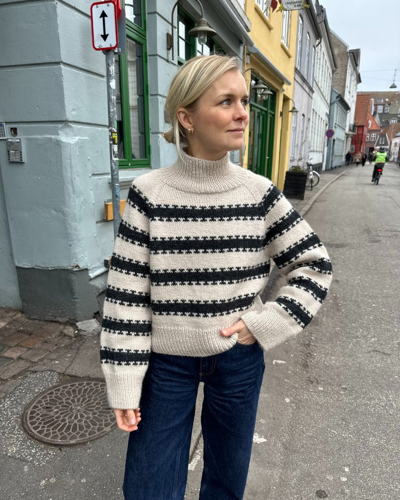 Kvinde iført hvid og grå Key Sweater 
