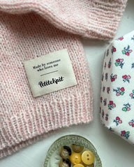 Made by someone who loves me label i bunden af lyserød striktrøje