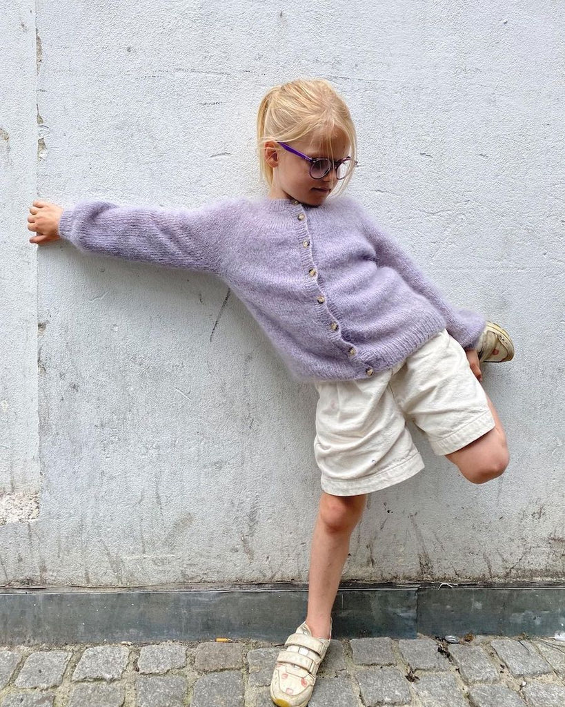 Barn iført lilla Novice Cardigan Junior – Mohair Edition