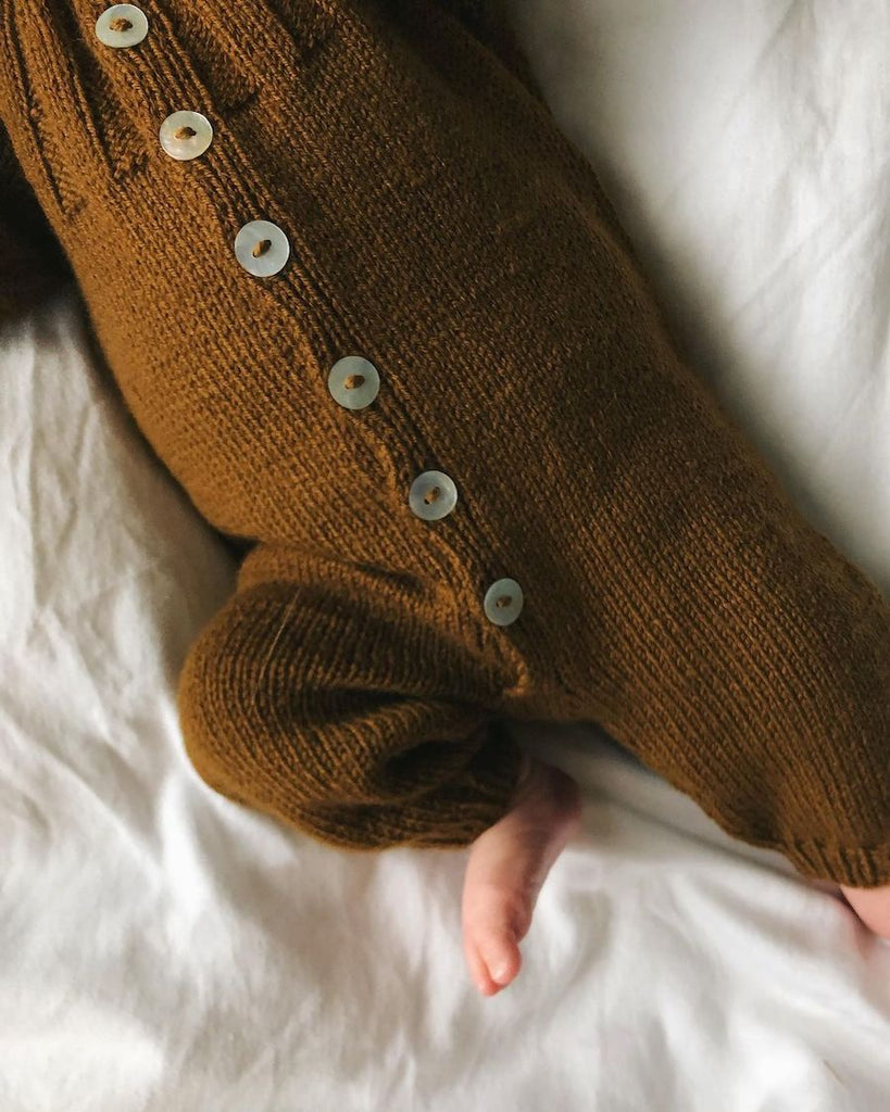 Detaljebillede af baby iført brunt Sunday Suit 