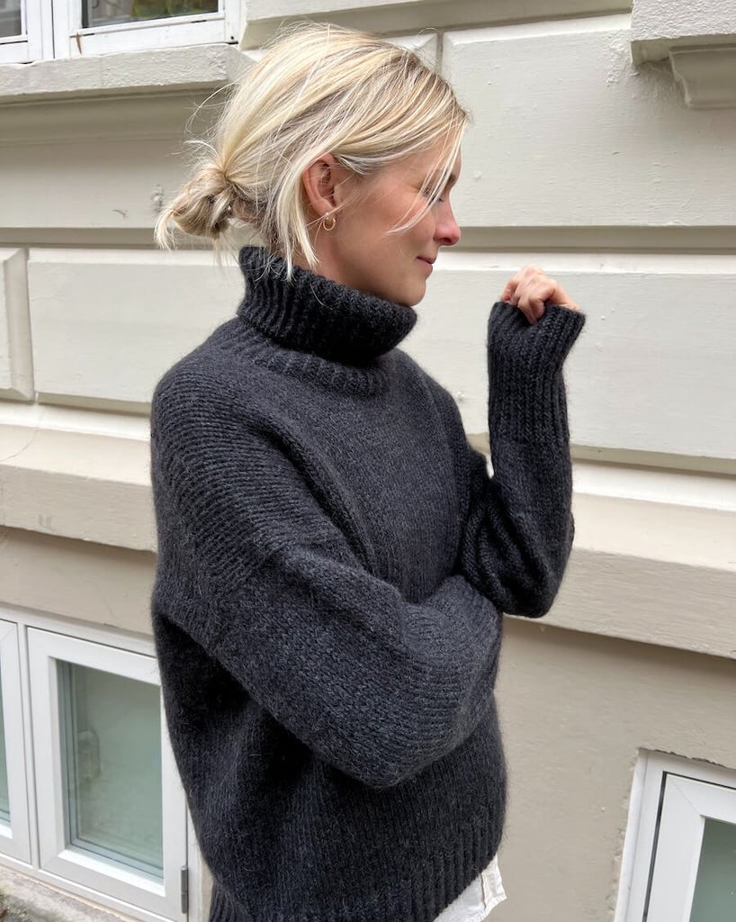 Kvinde iført koksgrå Wednesday Sweater